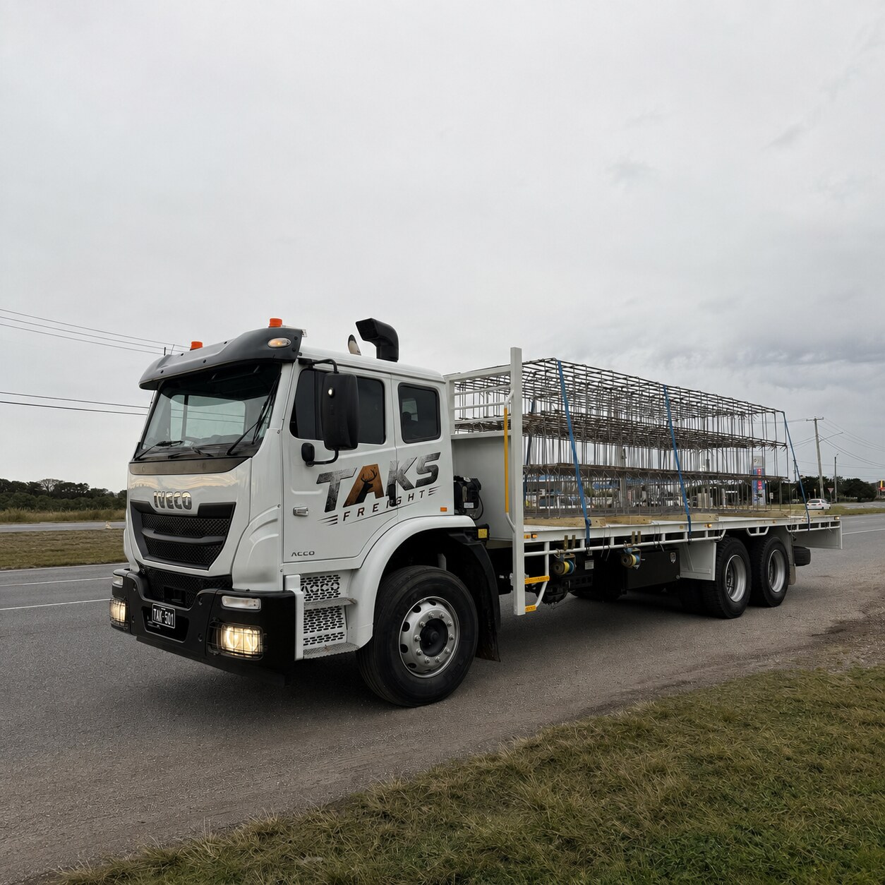 TAKS Freight heavy rigid truck carrying secured scaffold frames